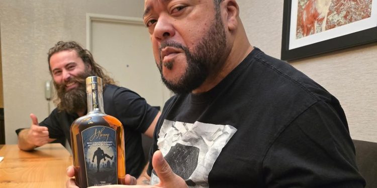 Gilbert and J. Henry with Gilbert holding his "Gravedigger Whiskey"