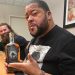 Gilbert and J. Henry with Gilbert holding his "Gravedigger Whiskey"